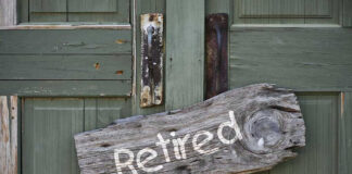 Wooden Retired sign on an old green door