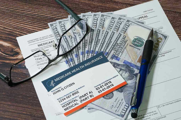2248274327 Medicare card glasses pen money on wooden table