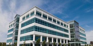 Modern office building with a glass facade and landscaped surroundings