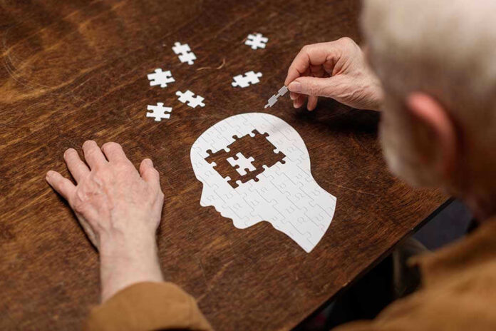 1776503864 Elderly person completing head-shaped jigsaw puzzle.