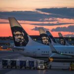 Aviation System Nearly COLLAPSES — Flights Grounded Nationwide Aircraft tails with a sunset backdrop at an airport