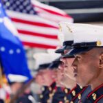Marine Veteran’s ATTACK Shocks Nation U.S. Marines in uniform standing in formation with flags in the background