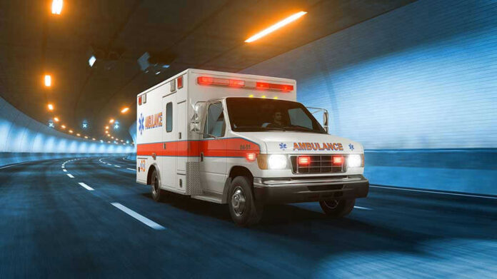 Ambulance driving through a brightly lit tunnel.