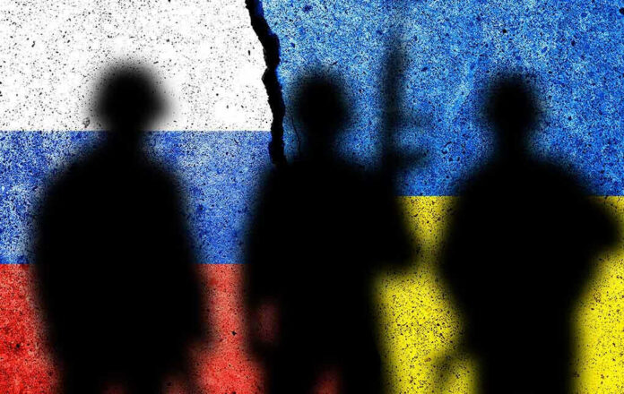 2095910923 Silhouettes against split Russian and Ukrainian flags.