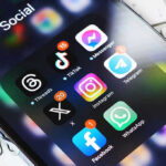 TikTok Star’s Final Post Hides Dark Twist Smartphone showing social media app icons in a folder.