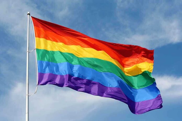 shutterstock_115334461.jpg A rainbow flag waving against a blue sky