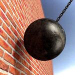 Demolition Order SHOCKS San Francisco Owner A wrecking ball suspended near a brick wall, suggesting demolition activity