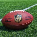 Biden HORRIFIES Football Fans An NFL football resting on a green grass field