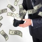 Wage Garnishment Resumes January 2026 A businessman holding a wallet with money flying out