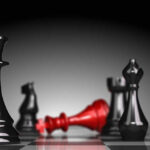 Ruthless Queenpin’s Heart-Ripping Rituals Black and red chess pieces on a board.