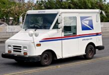 Panic Over Postal Hike: Could It Hit $1? White USPS delivery truck parked on a street