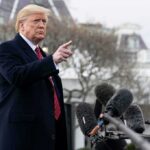 Donald Trump gesturing while speaking to the press outside