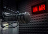 Radio microphone in studio with On Air sign.