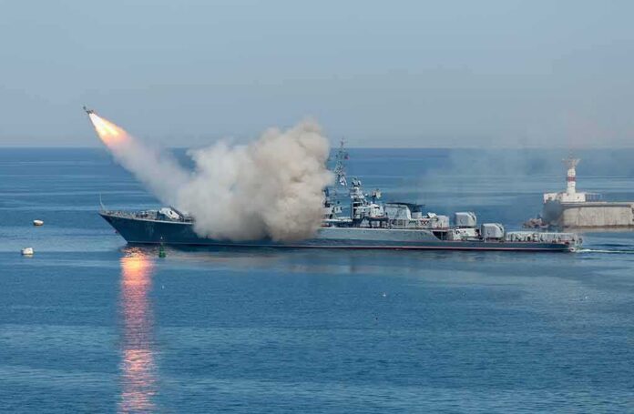 shutterstock_533229181-2- A military ship launching a missile into the ocean