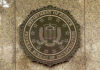FBI seal on a marble wall.