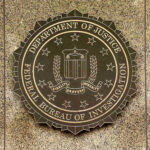 FBI Purge Over Anti-Catholic Memo FBI seal on a marble wall.