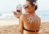 Decades Late: Better Sunscreen Finally Lands Woman applying sunscreen at the beach.