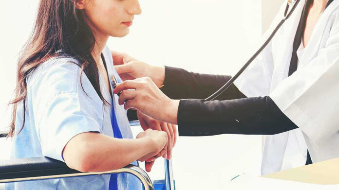 1630502584 Doctor examining patient with stethoscope in hospital