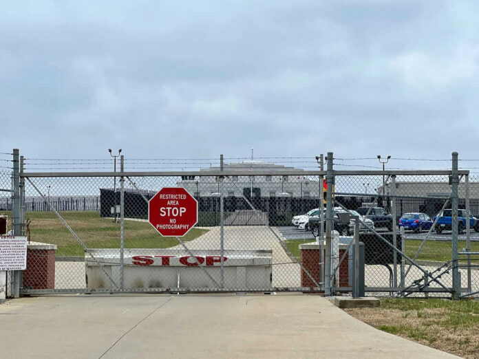2375002113-1 Chain-link fence with Restricted Area Stop No Photography sign.