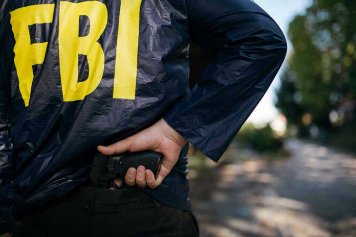 624106589 FBI agent holding a gun behind the back.