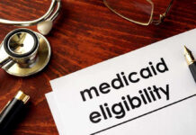 Multi-Agency Raid Targets Medicaid Swindle Stethoscope pen document about Medicaid eligibility on table