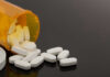 Heroin Spiral—VP’s Mom Breaks Silence Spilled prescription bottle with white pills.
