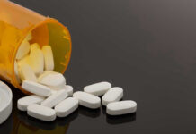 Heroin Spiral—VP’s Mom Breaks Silence Spilled prescription bottle with white pills.