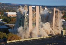 Killer Quake Slams Mindanao A building being demolished with dust and debris in the air
