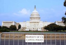 Democrats Rage As Iran Fight Halts View of the U.S. Capitol building with a security barrier in front