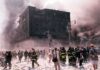 Emergency responders and civilians amidst debris at a disaster site