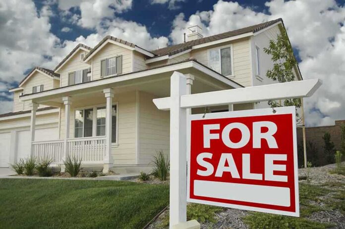 shutterstock_21431701 A suburban house with a For Sale sign in the front yard