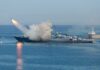 A military ship launching a missile into the ocean