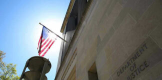 American flag at Department of Justice building exterior.
