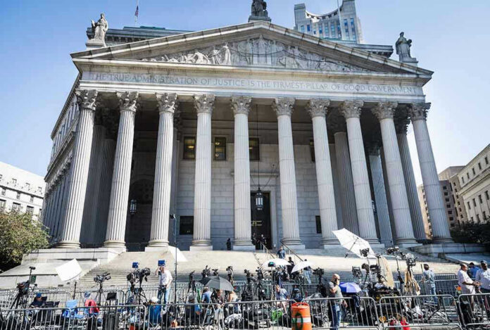 2445868619 Courthouse facade with media crews setting up outside.