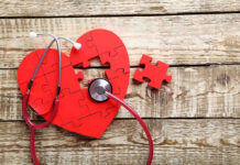 Graham Gone — Truth Drips Out Slowly Red heart puzzle with stethoscope on wooden background.
