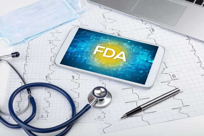 shutterstock_1701445117 Tablet with FDA on screen amid medical tools and ECG charts