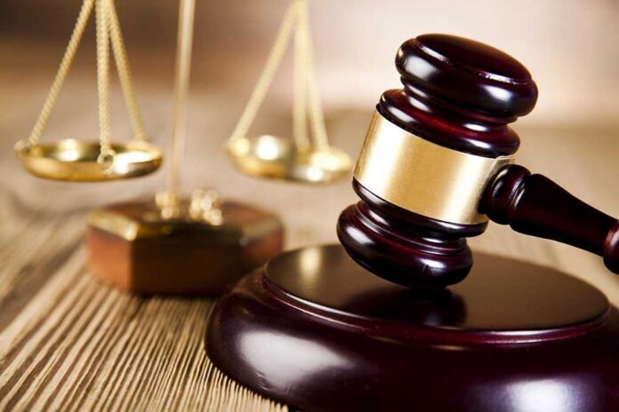 Justice,Scale,And,Gavel A wooden gavel and scales of justice on a table