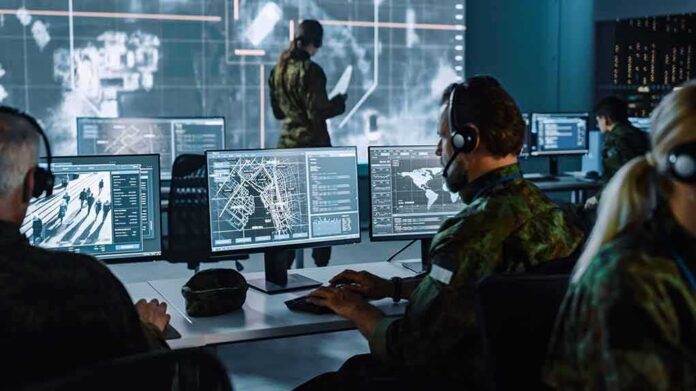 Military analysts at computers in a command center