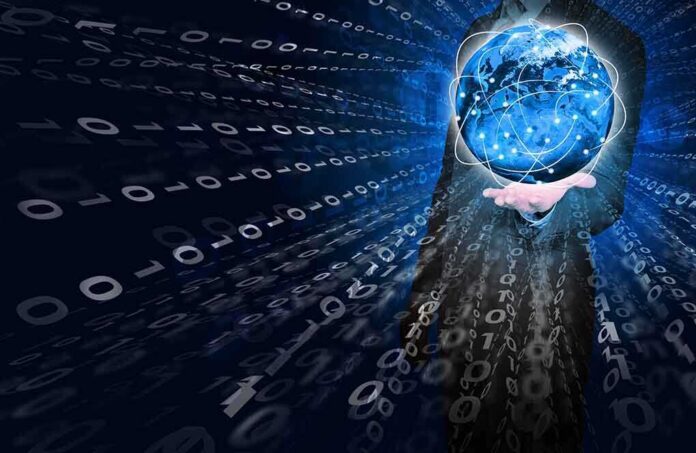 shutterstock_196320203 A businessman holding a glowing globe surrounded by binary code