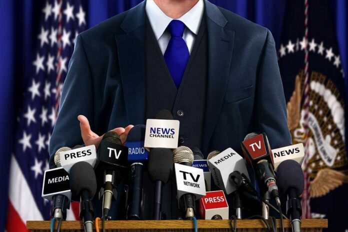 Politician,At,Press,Conference A speaker at a press conference with multiple microphones in front of them
