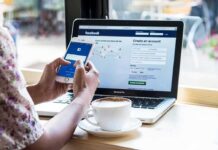 Mandatory ID To Scroll: France Goes First Hands using smartphone with laptop and coffee on cafe table