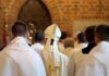 Bishop in white mitre among clergy during church procession