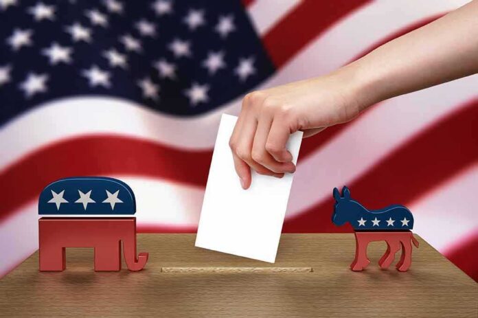 Hand casting ballot between Republican elephant and Democratic donkey