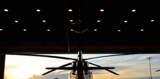 Helicopter in a hangar at sunset