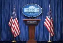 Trump Slams Brakes On Iran Strike White House press podium with microphones and two American flags