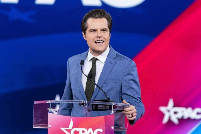 shutterstock_2187507899 man in blue suit speaking at a podium