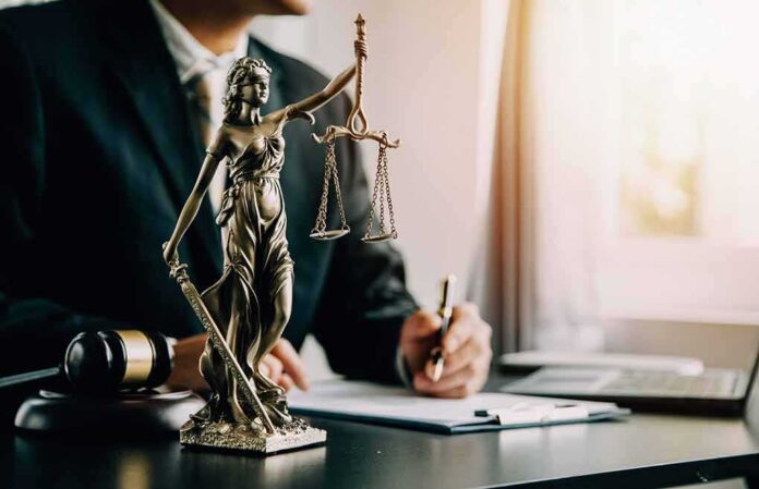 shutterstock_2390892835 Lady Justice statue on a lawyer’s desk