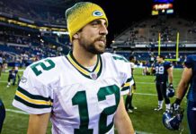 football player in white jersey and yellow beanie on the field