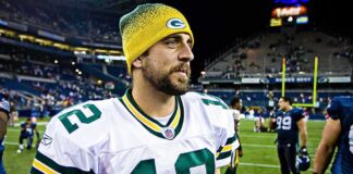 football player in white jersey and yellow beanie on the field