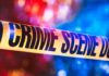 Serial Killer Panic? Cops Won’t Say Crime scene tape with blurred emergency lights in background